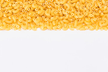Uncooked Chifferi Rigati Pasta Scattered on White Table. Fat and Unhealthy Food. Classic Dry...