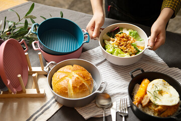 Various foods on the table, hands holding food