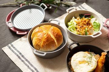 Salad, bread and various foods on the table