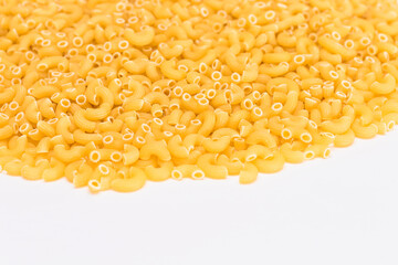 A Heap of Uncooked Chifferi Rigati Pasta on White Background. Fat and Unhealthy Food. Classic Dry Macaroni Texture. Italian Culture and Cuisine. Raw Pasta