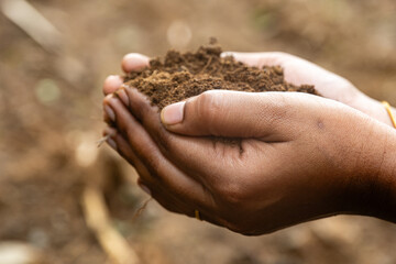 woman holds farm mud in her two hands