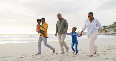 Happy, walking and a black family at the beach, holding hands and talking on a holiday. Sunset, conversation and grandparents, father and children on a walk by the sea during a vacation for travel - Powered by Adobe