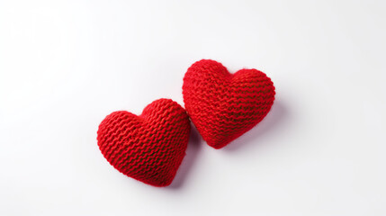 Two knitted red hearts on a white background. Valentine's Day.