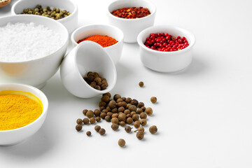 Various spices in a bowls on white background