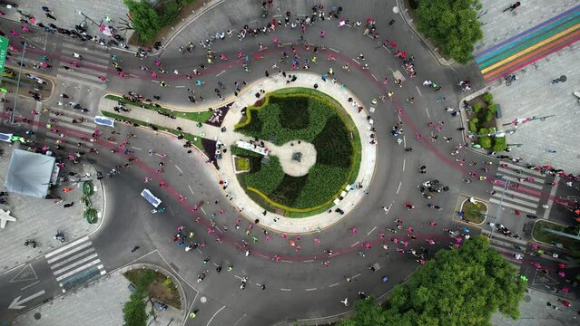 rotational Drone shot of runners passing during the Mexico City Marathon in Polanco in the morning