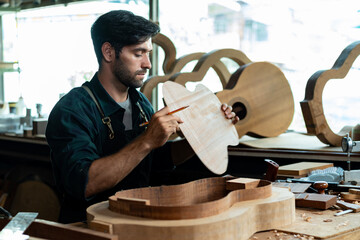 Guitar Luthier Ensures Back and Body Match in Mold - obrazy, fototapety, plakaty