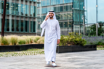 Arab middle-eastern man wearing emirati kandora traditional clothing in the city - Arabian muslim...