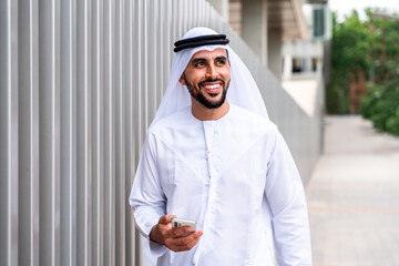 Arab middle-eastern man wearing emirati kandora traditional clothing in the city - Arabian muslim...