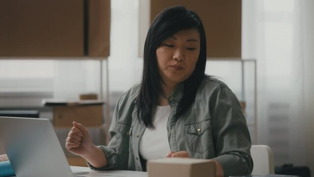 Asian businesswoman receives bad stats, decrease of business profits, high taxes