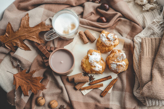 Beautiful cozy autumn background top view, candle, sweets and coffee