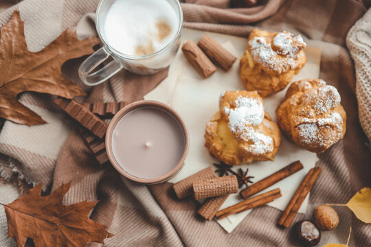 Beautiful cozy autumn background top view, candle, sweets and coffee