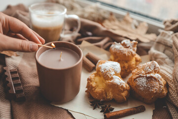 Lighting a candle, cozy autumn photo