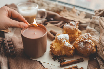 Lighting a candle, cozy autumn photo