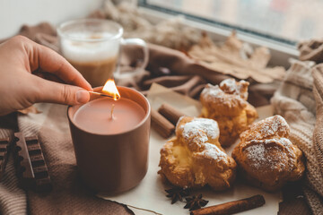 Lighting a candle, cozy autumn photo