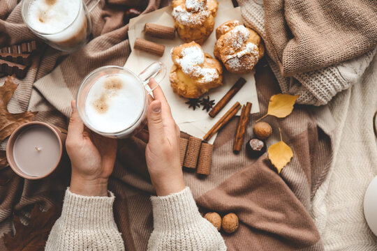 Cup of coffee in hands, cozy autumn
