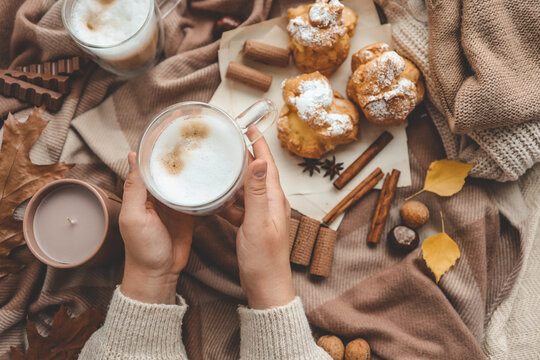 Cup of coffee in hands, cozy autumn