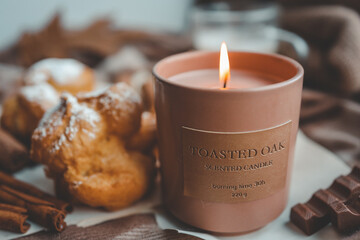 Burning candle with the smell of chocolate and cinnamon in a cozy home interior