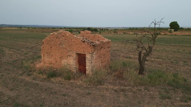 Aerial circling traditional rural tool shed in countryside, Tarrega, Spain