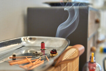 Traditional Chinese medicine tools on a tray. Acupuncture needles, moxibustion cones, cupping therapy