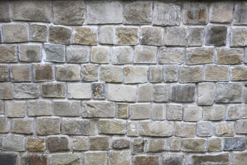 Texture of old grey stone wall with various stones