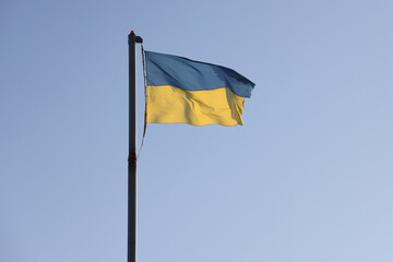 Ukraine flag large national symbol fluttering in blue sky. Large yellow blue Ukrainian state flag, Dnipro city, Independence Constitution Day