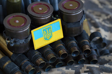 Ukrainian symbol on machine gun belt lies on ukrainian pixeled military camouflage