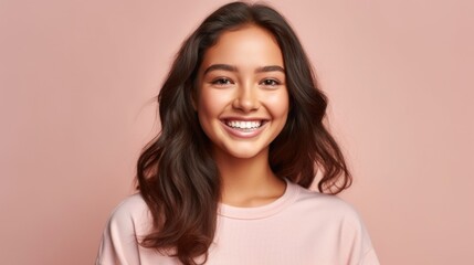 Fototapeta premium In this heartwarming portrait, a young teen girl's genuine smile takes center stage against a neutral studio background, a symbol of her youthful spirit and happiness.