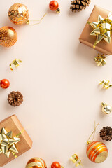 Seasonal Magic: vertical top view of gift packages, gleaming orange and gold ornaments, pinecones,...