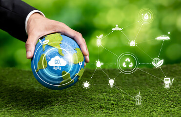Businessman's hand holding Earth globe symbolize corporate commitment to ESG or CSR to reduce...