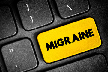 Migraine is a headache that can cause severe throbbing pain or a pulsing sensation, text button on keyboard, concept background