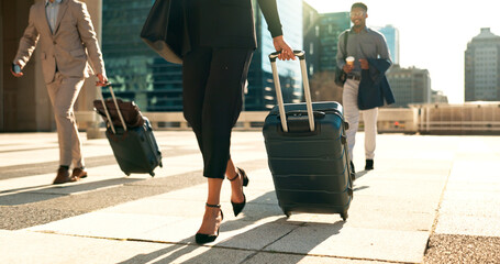 Business, legs and luggage for travel in city with corporate people walking to hotel, airport or business opportunity. Professional woman or men feet and steps with suitcase outdoor in career journey © N F/peopleimages.com
