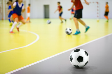 Indoor soccer training class for children. Soccer skills training. Futsal players in practice game...