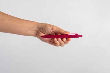 Hand holding pen isolated on white background