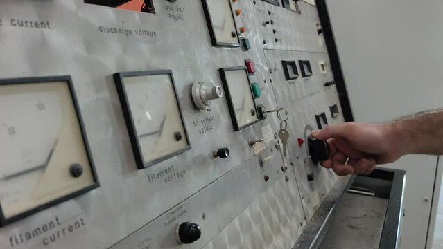 An engineer man or worker, people's hand Twisting knobs and pushing buttons. Controlling the machine&rsquo;s movement.  Man is using special equipment to aid production process and using control panel