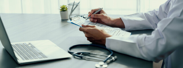 Doctor carefully review detailed medical report with laptop and diagnosing illness for effective...