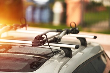 Versatile Roof Rack for Station Wagons: Safely Transporting Sports Equipment and Big Items. A roof rack or bar on a station wagon or estate car. Transportation of sports equipment in the family car. - obrazy, fototapety, plakaty