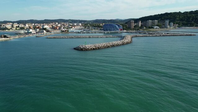 Drone footage over the Porto Di Pesaro - Molo Di Levante on a sunny day in Pesaro, Italy