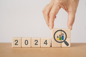 2024 wooden cube block with growing graph inside magnifying glass icon. SEO, Search Engine...