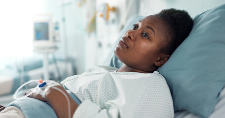 Sad, sick and a thinking black woman in a hospital bed for healthcare, exam and a surgery. Tired, depression and an African clinic patient in a ward for treatment help, mental health or a virus