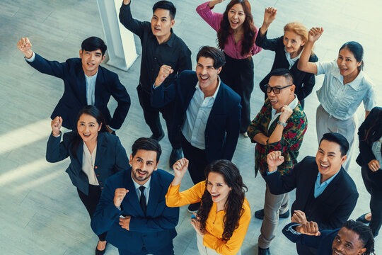 Happy Diverse Business People Celebrating Their Success Project.Top View. Group Of Successful Energetic Employees Cheer Up Gratefully While Looking At Sky With White Background. Intellectual.