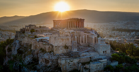 A golden sunrise behind the ancient Parthenon Temple at the Acropolis of Athens, Greece