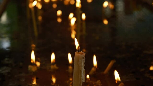 Church candles are burning  in the orthodox church. Burning candles in the orthodox church. Christian faith and traditions. Theme of faith and God, religion and traditions.
