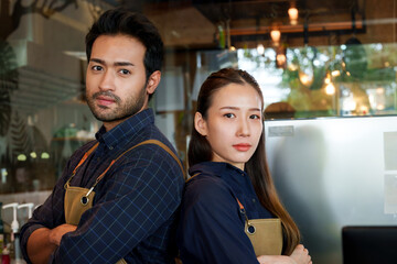 Beautiful Asian women and Asian men of multi nationality . They stood with their arms crossed and their backs to each other. to take pictures to promote a coffee shop that is  minimalist style shop
