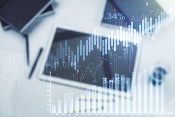 Multi exposure of abstract creative financial graph and modern digital tablet on background, top view, forex and investment concept