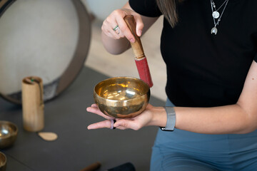 A girl plays Tibetan singing bowls.