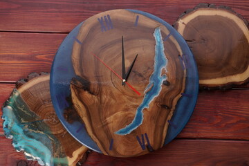 Wooden wall clock on background, top view