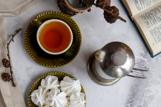 Christmas tea party with marshmallows. book is in unfolded form. hygge, coziness, comfort, winter lifestyle. Top view - Powered by Adobe