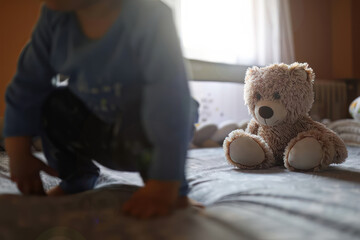 Cozy Bedtime Moments: Child in Pajamas with Beloved Teddy Bear