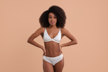 Obraz premium Beautiful woman in stylish bikini on beige background