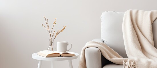 White cozy chair with a book and coffee in still life With copyspace for text